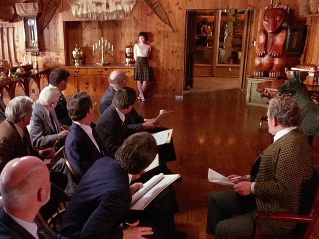 A screenshot of Audrey talking to the Norwegians in a conference room from the pilot episode of Twin Peaks.
